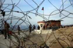 Afghan National Army soldiers stand guard at a checkpoint near the Bagram base in northern Kabul, Afghanistan, April 8, 2020.