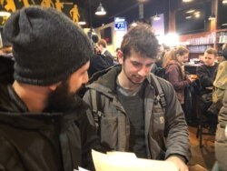 Brothers Alex and Jesse Khoury are prepping to canvas for Vermont Senator Bernie Sanders who narrowly leads most New Hampshire polls. (VOA/Carolyn Presutti)
