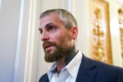 FILE - Michael Fanone, a Washington Metropolitan Police Department officer, leaves a meeting with House Minority Leader Kevin McCarthy, R-Calif., at the Capitol in Washington, June 25, 2021.