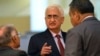 India's Foreign Minister Salman Khurshid speaks to his staff as they attend the 46th Association of Southeast Asian Nations (ASEAN) Foreign Ministers Meeting in Bandar Seri Begawan, July 1, 2013.