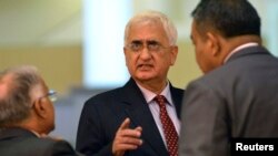 India's Foreign Minister Salman Khurshid speaks to his staff as they attend the 46th Association of Southeast Asian Nations (ASEAN) Foreign Ministers Meeting in Bandar Seri Begawan, July 1, 2013.