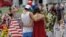 A couple spends a quiet moment at a makeshift memorial honoring the victims of the Pulse nightclub mass shooting in Orlando, Fla., June 20, 2016.