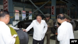 This undated photo released from North Korea's official Korean Central News Agency on Aug. 14, 2023 shows North Korea's leader Kim Jong Un, center, inspecting an important munitions factory at an undisclosed location in North Korea.