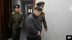 Hyeon Soo Lim, center, who pastors the Light Korean Presbyterian Church in Toronto, is escorted to his sentencing in Pyongyang, North Korea, Wednesday, Dec. 16, 2015.