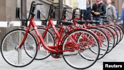 Bicycles with the Bank of Moscow log stand ready to rent in central Moscow, May 27, 2013.