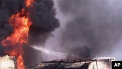 A Pakistani fire fighter tries to extinguish burning oil tankers after militants attacked a terminal in Quetta, Pakistan on Wednesday, Oct. 6, 2010.