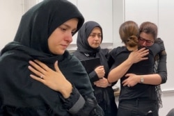 Mourners attend a vigil at University of Toronto student housing for the victims of a Ukrainian passenger jet, which crashed in Iran, in this still image taken from a video, in Toronto, Ontario, Canada, Jan. 8, 2020.