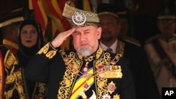 Malaysia King Sultan Muhammad V salutes during the national anthem at the opening of the 14th parliament session at the Parliament house in Kuala Lumpur, July 17, 2018. 