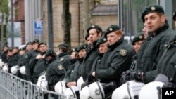 German police officers guard the Deutsche Bank building during a demonstration by anti-capitalism Blockupy protesters in front of the European Central Bank in Frankfurt, May 31, 2013.