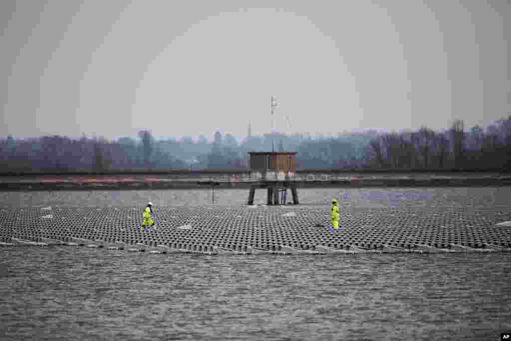 Contractors continue work on Europe&#39;s biggest floating solar panel array as it nears completion on the Queen Elizabeth II Reservoir near Walton-on-Thames in south west London.