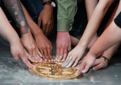 FILE - Pro-democracy student leaders install a plaque declaring 'This country belongs to the people' at the Sanam Luang field during a protest in Bangkok, Thailand, Sept. 20, 2020.