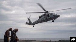 In this handout photo provided by the U.S. Navy, MH-60S Sea Hawk lands on the flight deck of the Nimitz-class aircraft carrier USS Theodore Roosevelt during exercise Freedom Edge, June 29, 2024. (Mass Communication Specialist Seaman Aaron Haro Gonzalez/U.S. Navy via AP)
