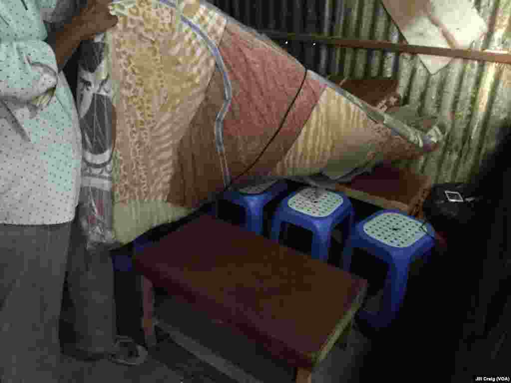 A Yemeni refugee pulls up the mattress in his home to show his bed. He also operates al-Shaibani Restaurant in his home, in Hargeisa, Somaliland, March 30, 2016.