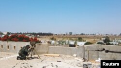 FILE - A member of the Libyan internationally recognized government forces is seen during a fight with Eastern forces, in southern Tripoli, Libya, June 22, 2019.