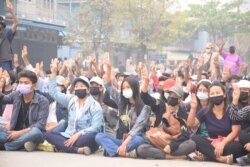 Anti-coup protesters flash the three-finger salute, a symbol of resistance, during a sit-in in Kalay, Sagaing region, Myanmar, March 30, 2021. (Credit: Citizen journalist via VOA Burmese Service)