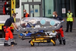 German army emergency personnel load into their ambulance the stretcher that was used to transport Russian opposition figure Alexei Navalny on at Berlin's Charite hospital, Aug. 22, 2020.