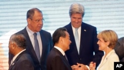 Russia's Foreign Minister Sergey Lavrov, U.S. Secretary of State John Kerry, rear, stand with India's Minister of External Foreign Affairs General V.K. Singh, left, China's Foreign Minister Wang Yi, center, and Australia's Foreign Minister Julie Bishop as