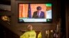 People in a bar watch the speech of Catalan regional president Carles Puigdemont on television in Barcelona, Spain, Oct. 26, 2017.