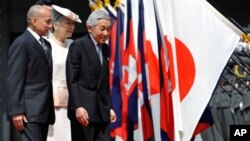 Cambodian King Norodom Sihamoni, left, follows Japanese Emperor Akihito, right, and Empress Michiko, center, on their way to a welcoming ceremony at the Imperial Palace, in Tokyo, Japan, file photo. 
