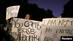 FILE - People rally to protest the Trump administration's reported proposal to narrow the definition of gender to male or female at birth, in Los Angeles, Oct. 22, 2018. 