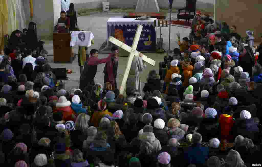 Belarussian Catholics re-enact a moment in the life of Jesus Christ in a Catholic church before a procession to celebrate Palm Sunday in the town of Oshmiany.