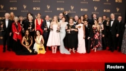 The Handmaid's Tale cast and crew pose with their Emmys. 