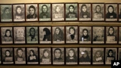 Mug shots of former prisoners hang on the wall at a former prison run by the pre-revolution intelligence service, Savak, now a museum, in downtown Tehran, Jan. 7, 2019. 