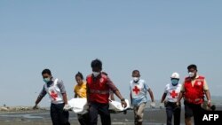 Members of the Myanmar Red Cross carry the body of the driver of a United Nations-marked vehicle after it came under attack while delivering test samples for coronavirus, in Sittwe, Rakhine state, April 21, 2020. 
