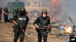 Egyptian security forces clear a sit-in camp set up by supporters of ousted President Mohamed Morsi in Nasr City district, Cairo, Aug. 14, 2013.