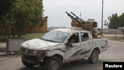 Turkey-backed Syrian rebel fighters return from the Syrian border town of Tal Abyad, see here on the Turkish-Syrian border in Akcakale, Turkey, Oct. 19, 2019. 