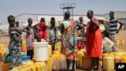 FILE - Residents of a camp for the internally-displaced line up to get water from a borehole, on the outskirts of the capital Juba, South Sudan, Jan. 22, 2019. 