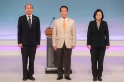 FILE - Taiwan's 2020 presidential election candidates, from right, Democratic Progressive Party's Tsai Ing-wen, People First Party's James Soong, and Nationalist Party's Han Kuo-yu attend a televised policy debate in Taipei, Taiwan, Dec. 29, 2019.