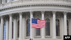 A U.S. flag is raised at the U.S. Capitol in Washington, Jan. 20, 2021.