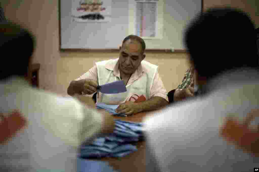 An official counts ballots at a polling station in Tripoli, Libya, Saturday, July 7, 2012. 