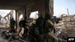 This handout picture released by the Israeli army on May 14, 2024 shows Israeli soldiers during military operations in the Gaza Strip, amid the ongoing conflict between Israel and the Palestinian militant group Hamas.