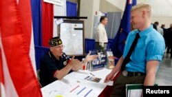 A U.S. veteran gets information at the Veterans Administration booth at the "Hire Our Heroes" Job fair in Sandy, Utah, March 25, 2014.