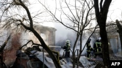 Rescuers work to extinguish a fire in a house following a drone attack in the village of Stanovoye, Moscow region, on November 10, 2024.