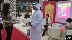 An exhibitor talks to a visitor to The World Halal Travel Summit & Exhibition in Abu Dhabi, United Arab Emirates. Muslim countries in Southeast Asia hope the U.S. travel ban on people from 7 Muslim-majority countries will help them increase tourism. 