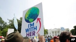 FILE - Participants walk along Pennsylvania Avenue in front of the White House in Washington, during a demonstration and march, April 29, 2017.