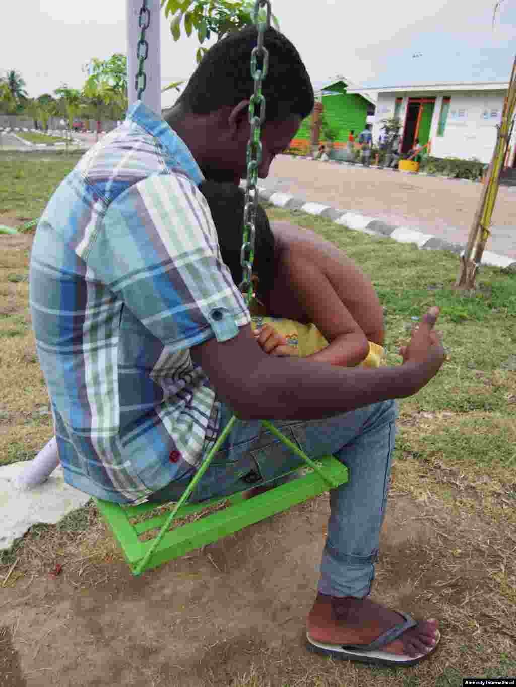 A Rohingya man and child in Indonesia.