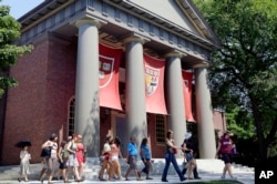 Harvard University is vowing to spend $100 million dollars to research and atone for its extensive ties with slavery, the school's president announced Tuesday, April 26, 2022, with plans to identify and support direct descendants of dozens of enslaved people who labored at the Ivy League campus. (AP Photo/Elise Amendola, File)
