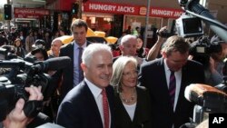 Prime Minister Malcolm Turnbull greets people during a walk through a shopping street in Burwood, Sydney, Australia, Friday, July 1, 2016. 