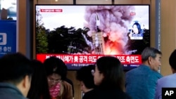 People watch a TV showing a file image of North Korea's missile launch during a news program at the Seoul Railway Station in Seoul, South Korea, Oct. 2, 2019.