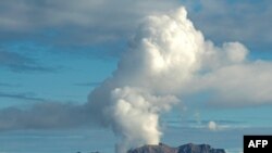 This handout photo taken on July 23, 2019 and released to AFP courtesy of Chris Firkin on Dec. 9, 2019 shows the volcano on New Zealand's White Island spewing steam and ash.