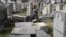 Rabbi Joshua Bolton of the University of Pennsylvania's Hillel center surveys damaged headstones at Mount Carmel Cemetery, Feb. 27, 2017, in Philadelphia.