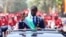 Senegalese President Bassirou Diomaye Faye waves to supporters from a car after taking the oath of office as president during his inauguration ceremony near Dakar on April 2, 2024.