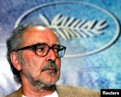 FILE - Swiss director Jean-Luc Godard listens to question during a press conference for his film entry 'Notre Musique' which is screened out of competition at the 57th Cannes Film Festival, May 18, 2004. (REUTERS/Vincent Kessler/File Photo)
