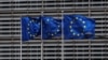 FILE - European Union flags flutter outside the EU Commission headquarters in Brussels, Belgium, May 5, 2021. 