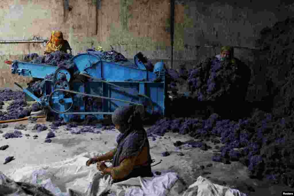 Women work in a factory where clothing waste is transformed into cotton to make mattresses, in Narayanganj, Bangladesh.
