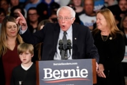 Democratic presidential candidate Sen. Bernie Sanders, I-Vt., with his wife Jane O'Meara Sanders, speaks to supporters at a caucus night campaign rally in Des Moines, Iowa, Feb. 3, 2020.